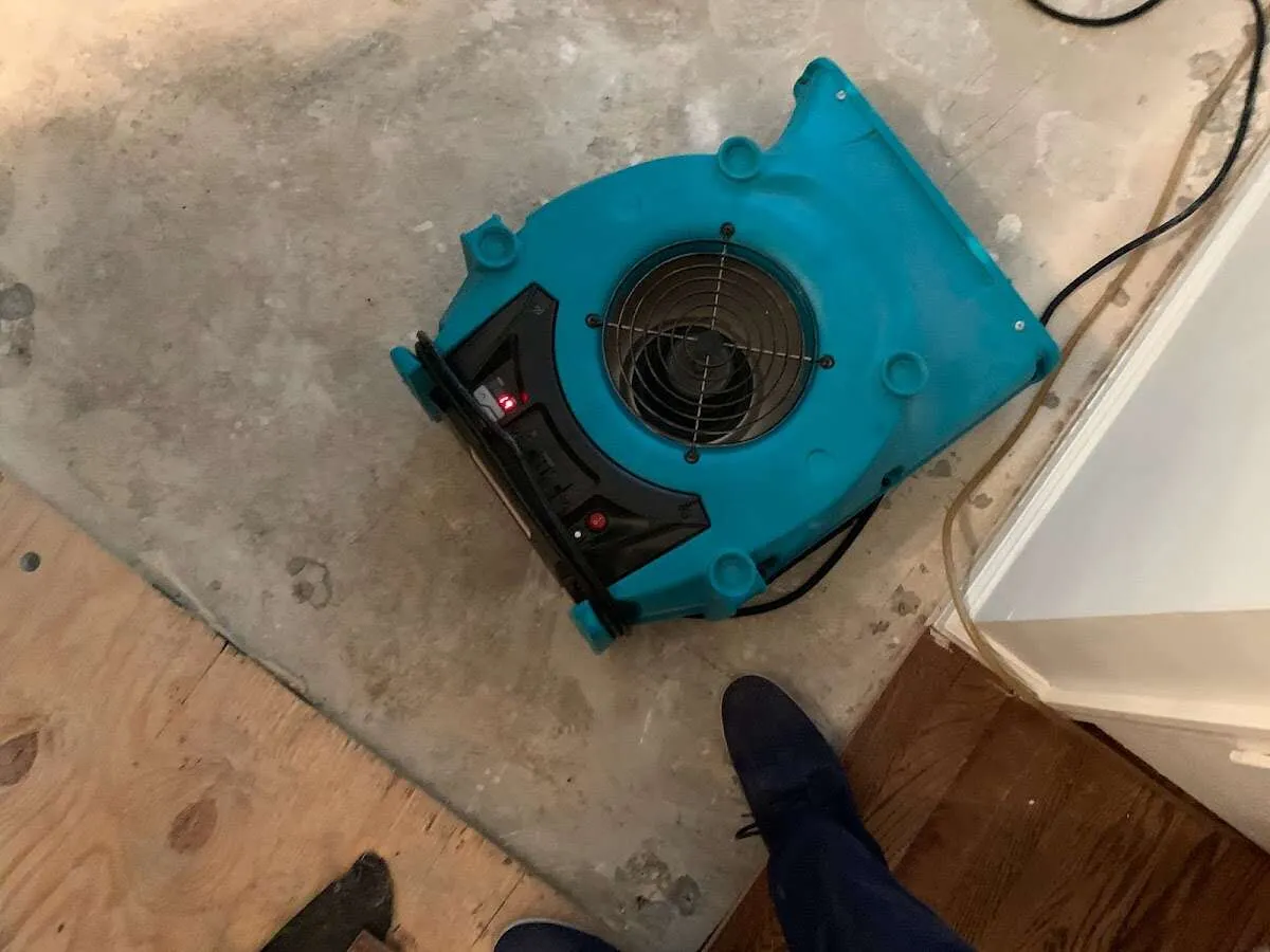 Air mover drying subfloor during Leak Detection & Repair in Conneaut